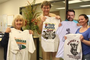 Kind Behind the Eyes-- Friends at South Yukon Church of Christ show some of the T-shirts they received for tornado relief. Pictured (l-r) are: Karla Stockton (office coordinator), Clyde Hughes (Mayberry Nut.), Perry Greene (minister) and Holly Gooch (office technician). 